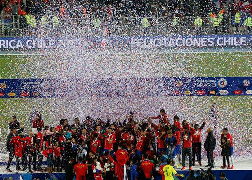 Chile's players celebrate with the Copa America trophy after winning the Copa America final soccer match between Chile and Argentina  during the Copa America final soccer match at the National Stadium in Santiago, Chile, Saturday, July 4, 2015. (AP Photo/Silvia Izquierdo)