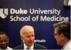 Vice President Joe Biden speaks with Dr. John Sampson, right, as Dr. A. Eugene Washington, left, listens in a laboratory at Duke University School of Medicine in Durham, N.C. Wednesday, Feb. 10, 2016. Vice President Joe Biden visited Duke University Medical Center to speak about his Cancer Moonshot initiative. (AP Photo/Ben McKeown)