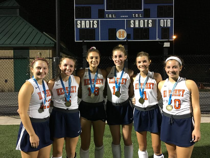 Left to right: HHS seniors Taylor Massage, Natalie Sicher, Mya Christopher, Jacqui Foley, Katie McCartney, and Ali Cronin pose for a photo while wearing their Mid Penn Champion metals. The field hockey team beat East Pennsboro 4-0. (Broadcaster/ Bella D’Adderio)