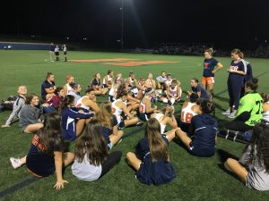 Hershey High’s Field Hockey team discusses the first half of the game during half time. The Trojans finished with a score of 4-0, and became the Mid Penn Conference champs of 2016. (Broadcaster/ Bella D’Adderio) 