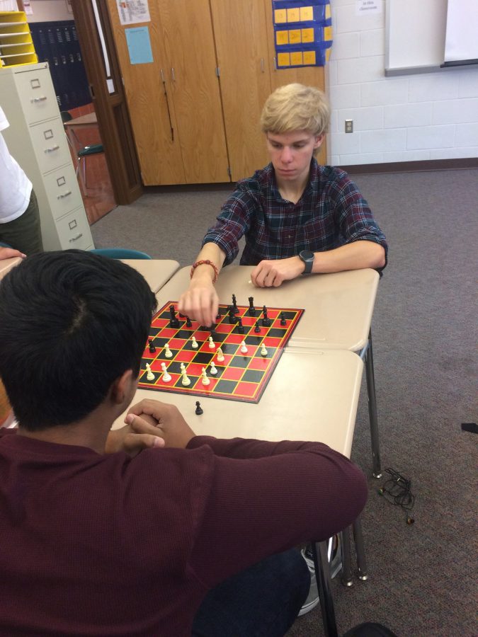 Leader of Chess Club, Valdimer Kellachow, a junior at HHS, takes his turn during a chess game against his opponent during Community Day on October 7th, 2016. Chess club held a tournament last year with both high school and middle school students (Broadcaster/Kate Sinz)
