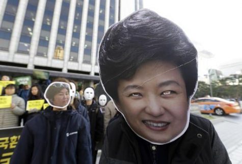 South Korean protesters wearing masks of South Korean President Park Geun-hye, right, and Choi Soon-sil, who is at the center of a political scandal, stage a rally calling for Park to step down in downtown Seoul, South Korea, Wednesday, Nov. 2, 2016. South Korea's embattled president has replaced her prime minister and two other top officials in a bid to restore public confidence amid a political scandal involving her longtime friend. (AP Photo/Ahn Young-joon) 