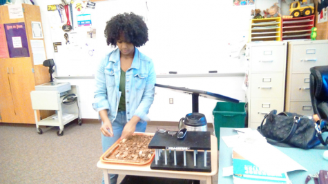 Kidist Aderaw, Hershey High School Sophomore, makes a snake of pennies during session 3 of the 2nd Annual Community Day. She decided to make this snake after seeing a tray of pennies in Mr. Roger’s room. (Broadcaster/Daniella Mimosa) 