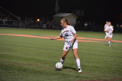 Katelyn Cocco, number 12, keeps the ball close to her. Cocco ended the game with one assist. (Broadcaster/Azelin Thompson)