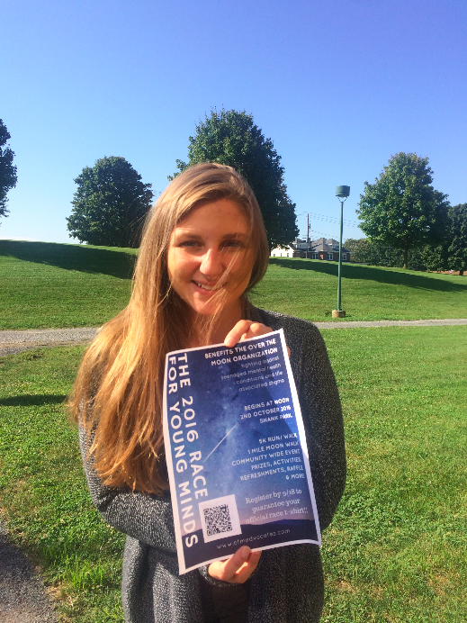 On September 23, 2016, HHS senior Rachael Schirato poses with a flier for the Race for Young Minds at HHS. Schirato, with the help of many others, organized this walk to benefit her mental health awareness non-profit, the Over the Moon Foundation. (Cara McErlean/ Broadcaster)