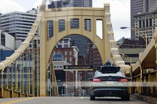 A self-driving Uber car crosses the ninth street bridge in Pittsburgh on September 14, 2016. On that same day, self-driving Ford Fusions began picking up Uber riders who volunteered to participate in a test program. (AP Photo/Gene J. Puskar)