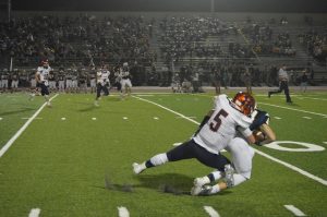 Junior Ryan Nerino tackles Cedar Cliff player during their game on Friday, October 7.  Nerino has been the quarterback for the Trojans for the past two years. (Broadcaster/Anna Levin)