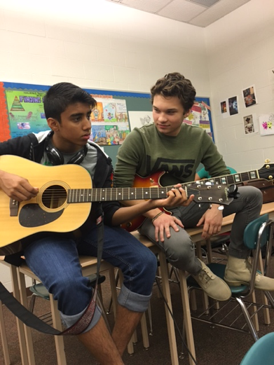 On October 7th, 2016, student Wyatt Roush teaches first time guitar player, Ahmed Khan the basics. Roush is currently working on his third album at Sugarcane Studios. 
(Broadcaster/Emerson Freer)