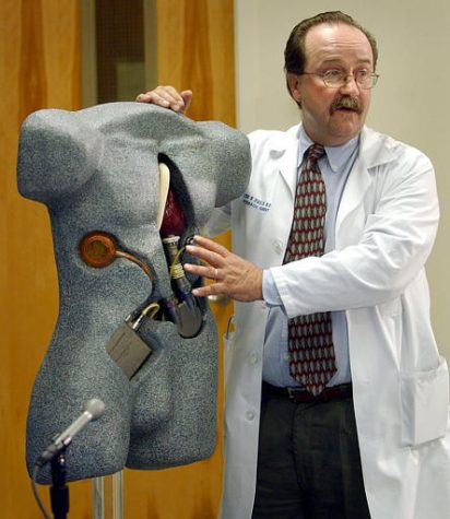 Dr. Walter E. Pae Jr., uses a life-sized model to explain the operation of the Arrow LionHeart heart-assist device Tuesday, June 24, 2003, during a news conference at Penn State's Milton S. Hershey Medical Center in Hershey, Pa. Gayle Snider, 35, went back to his York, Pa., home Monday, less than six weeks after he was implanted with the Arrow LionHeart, which can be fully implanted in the body without any cords or tubes passing through the skin. (AP Photo/Carolyn Kaster)