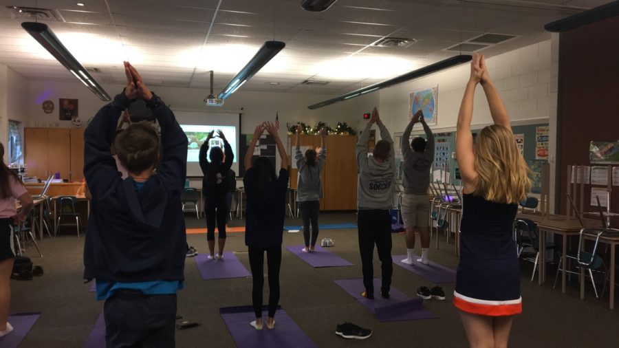 HHS students set up in  mountain pose at the start of the Power Vinyasa Yoga session. The session is part of the 2016 HHS Community Day. (The Broadcaster/ Emily Liesch)