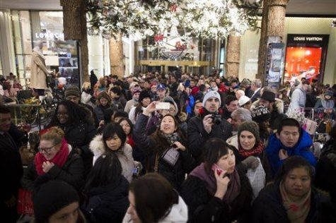 A shopper takes a selfie as crowds pour into the Macy's Herald Square flagship store, Thursday, Nov. 28, 2013, in New York. Instead of waiting for Black Friday, which is typically the year's biggest shopping day, more than a dozen major retailers are opening on Thanksgiving this year. (AP Photo/John Minchillo)
