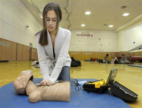Student Olivia Frierson presses contact pads from an AED machine onto a CPR mannequin during a CPR training class at Shaker Heights High School in Shaker Heights, Ohio on Monday, Jan. 10, 2011. The American Heart Association said Monday that all secondary school students should be required to be trained in cardiopulmonary resuscitation (CPR) and receive an overview of automated external defibrillators (AEDs). (AP Photo/Amy Sancetta)