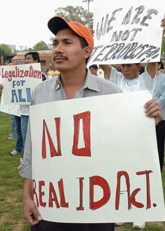 An unidentified man protests against the Real ID Act, with other immigrants who gathered on the field at Richard Montgomery High School for a rally, sponsored by CASA of Maryland, Saturday, May 7, 2005 in Rockville, Md. Hundreds of Latino immigrants, many of them illegal, gathered Saturday to protest proposed federal restrictions that would deny them driver's licenses and tighten asylum laws. (AP Photo/Leslie E. Kossoff)