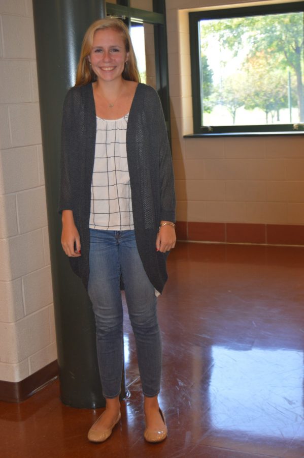 Madi Held, junior, styles her fall outfits with a simple shirt and sweater. Held wore jeans and flats to add a classy touch to her shirt and sweater combo.  (Elaina Joyner/ Broadcaster)