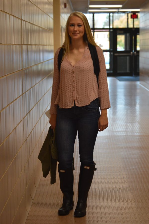 Hannah Malmer, junior, shows off her trendy hunter boots with a thin pink polka dotted shirt, army green jacket, and jeans. (Elaina Joyner/ Broadcaster)