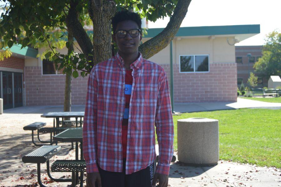 HHS freshman Akiva Brooks dresses for the fall season with a red flannel and a red shirt underneath. Brooks decided to go with black sweatpants to match the red, white, and blue in his outfit. (Broadcaster/ Elaina Joyner) 