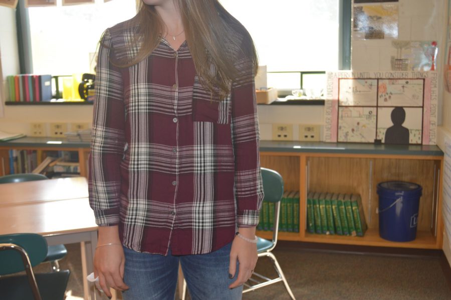 Baylee West, HHS sophomore, poses for a picture of her fall attire for the school day. West dresses to impress everyday with outfits including flannels and jeans. To add to her look, West put on  “Lokai” and “Alex and Ani” bracelets.