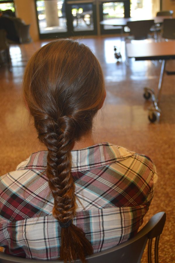 Freshman, Claire Sheppard, styles her hair with a casual fishtail braid to complement her flannel top. (Elaina Joyner/ Broadcaster)