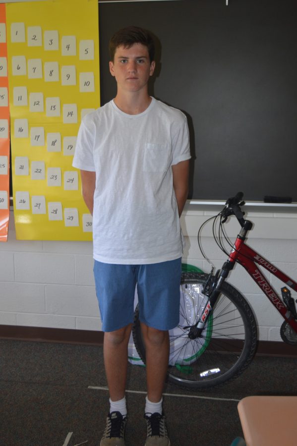 Freshman Will Miller pulls off a white shirt and blue shorts for his fall fashion. To complete his outfit, Miller wore comfortable Nike sneakers and white Nike high socks. (Elaina Joyner/ Broadcaster)