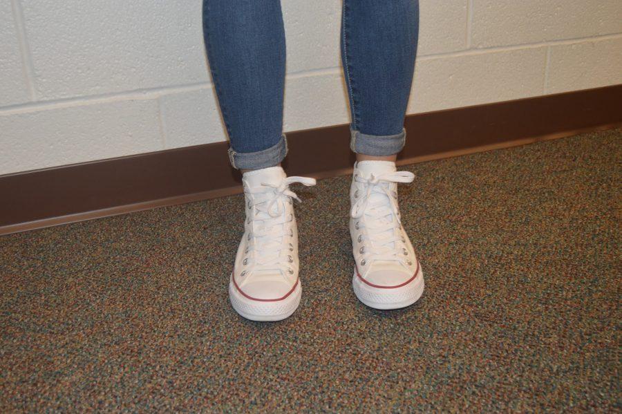 To complete her outfit sophomore Molly Glus sports in-style high top white Converse. The white Converse match with anything and can complete a look. (Elaina Joyner/ Broadcaster)
