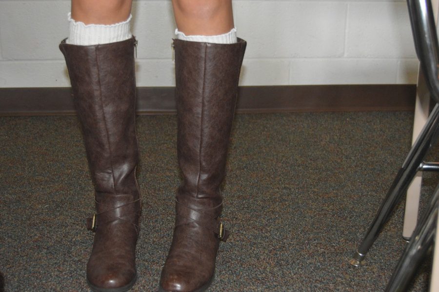 These trendy and comfortable tall brown boots, worn by sophomore Maddie Fahnestock, go perfectly with a large range of outfits. Outfits including skirts, dresses, and pants all go with these boots from DSW. (Elaina Joyner/ Broadcaster)