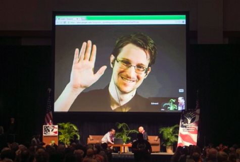 FILE - In this Feb. 14, 2015 file photo, Edward Snowden appears on a live video feed broadcast from Moscow at an event sponsored by ACLU Hawaii in Honolulu. The Valley News reports that Snowden, a former National Security Agency worker, will participate in a 30-minute discussion and Q&A at the New Hampshire Free State Project's convention in Manchester in February 2016. (AP Photo/Marco Garcia, File)