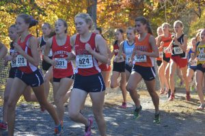 Taylor Mortensen, senior, runs by shortly after the start of the 5k race. Mortensen placed 49th overall. (Broadcaster/Moxie Thompson)