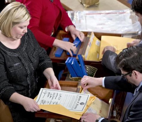 In this Jan. 4, 2013 file photo, clerks unseal the certificates of results from all fifty states during a meeting of the U.S. Electoral College in the House of Representatives on Capitol in Washington. The Electoral College was devised at the Constitutional Convention in 1787. It was a compromise meant to strike a balance between those who wanted popular elections for president and those who wanted no public input. (AP Photo/J. Scott Applewhite, File) 