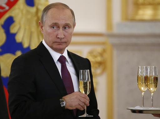 In this Nov. 9, 2016, photo, Russian President Vladimir Putin makes a toast during a ceremony for receiving diplomatic credentials from foreign ambassadors in the Kremlin in Moscow, Russia. In careful phrasing befitting the spy he once was, Vladimir Putin has made it clear he expects a great deal from President-elect Donald Trump. And, the billionaire businessman may expect a transactional relationship with Putin. (Sergei Karpukhin/Pool photo via AP)
