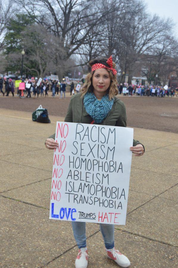 Nadina Feakins of Lancaster, Pennsylvania holds a sign promoting equality in Lincoln Park, Washington DC. Feakins, originally from Argentina, came to the march with two of her friends to not only show their support for women but to also advocate for immigrants. (Broadcaster/ Emily Liesch)