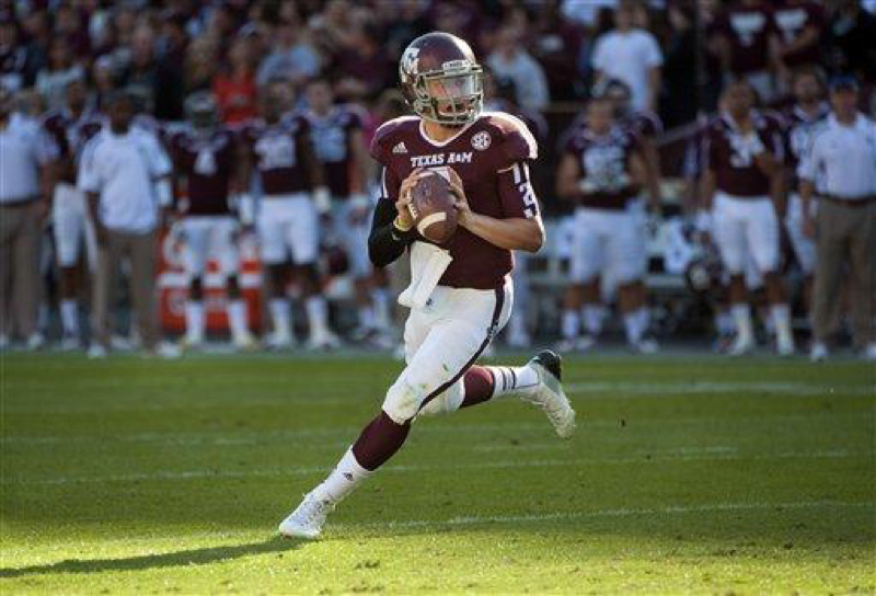 On Nov. 17, 2012, Texas A&Ms Johnny Manziel rolls out to throw a touchdown pass during the first quarter of an NCAA college football game against Sam Houston State in College Station, Texas. Manziel became the first freshman to win the Heisman Trophy when the award was presented the next Saturday night. (AP Photo/Dave Einsel, File)
