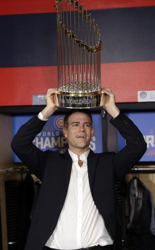 Epstein holding up the championship trophy after the Cubs win the seventh game of the World Series. It was the first Cubs championship since 1908. (AP Images/David J. Phillip)