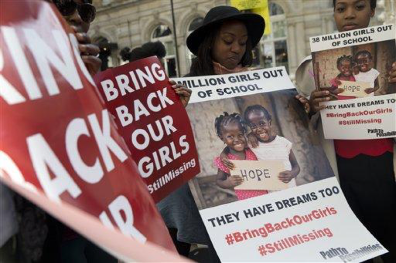 Protesters holds up placards demanding help from the Nigerian government to find the some 219 girls who remain missing on the first anniversary of the kidnapping by Islamic extremists, during a demonstration outside the Nigerian High Commission in London, Tuesday, April 14, 2015. April 14th marks the one year anniversary of the abduction from their school in Chibok, Nigeria, but Nigerias President-elect Muhammadu Buhari said Tuesday that We do not know if the Chibok girls can be rescued. Their whereabouts remain unknown. (AP Photo/Alastair Grant)