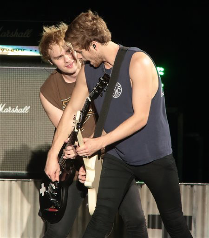 Michael Clifford, left, and Luke Hemmings of the band 5 Seconds of Summer perform in concert during their “Rock Out with Your Socks Out Tour 2015” at Hershey Stadium on Saturday, Aug. 29, 2015, in Hershey, Pa. (Photo by Owen Sweeney/Invision/AP)