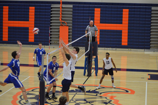 Senior Jack Quillen and Junior Jordan Spidle jump above the net to block a shot from a Lower Dauphin player. The Falcons later went on to win the game. (Broadcaster/ Madi Held) 
