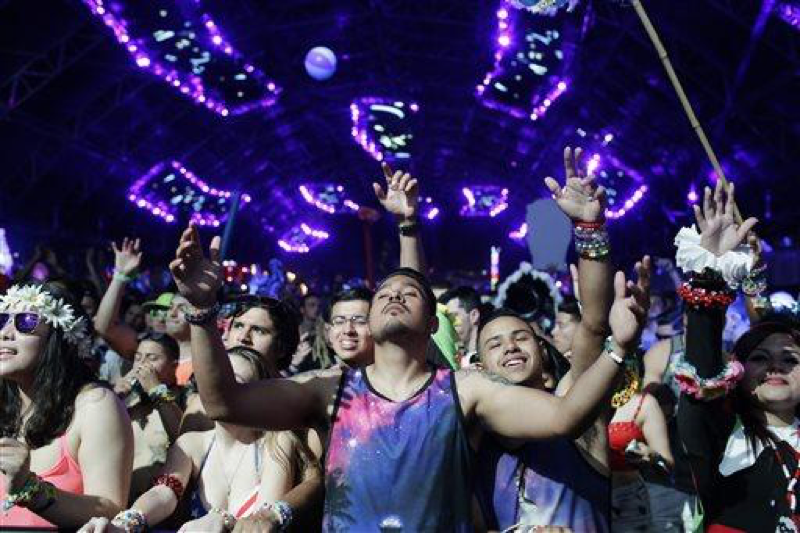 Festival goers listen to the music of Ummet Ozcan at the Circuit Grounds stage of the Electric Daisy Carnival, Friday, June 20, 2014, in Las Vegas. The festival has eight stages in addition to carnival rides and art installations. (AP Photo/John Locher)
