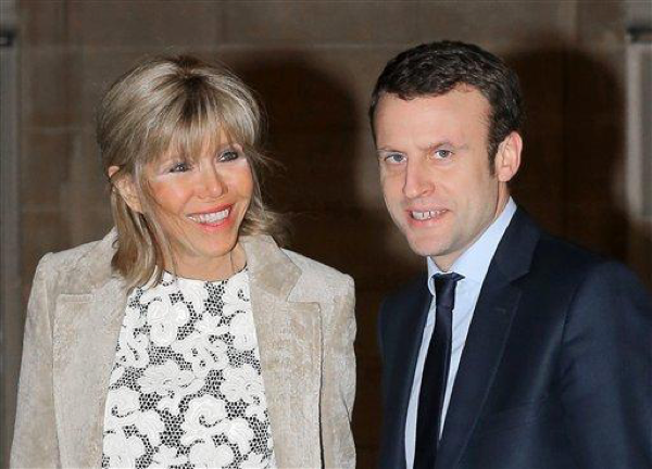 French Economy Minister Emmanuel Macron, right, and his wife Brigitte Trogneux arrive at the Elysee presidential palace in Paris to attend a state dinner, Thursday, March 10, 2016.(AP Photo/Jacques Brinon)