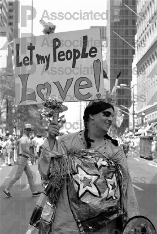 One of 50,000 marchers carries a sign during New York’s annual Gay Pride Day parade, June 28, 1981. The parade, which commemorated the 12th anniversary of the Stonewall riot, moved up Fifth Avenue to a rally in Central Park. (AP Photo/G. Paul Burnett)
