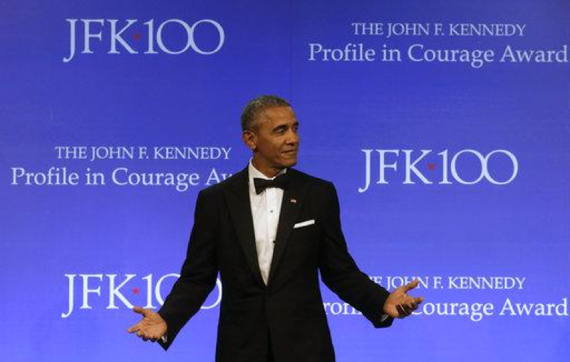 In this May 7, 2017, file photo, former President Barack Obama walks toward a podium to address an audience after being presented with the 2017 Profile in Courage award during ceremonies at the John F. Kennedy Presidential Library and Museum. Former President Barack Obama is starting to define his new role in the age of Donald Trump. After dropping out of sight for a pair of glamorous island getaways, Obama is emerging for a series of paid and unpaid speeches, drawing sharp contrasts with Trump even as he avoids saying the new president’s name. (AP Photo/Steven Senne)