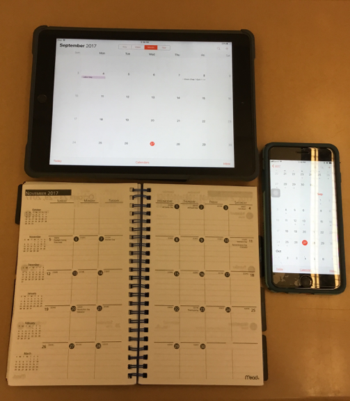 An iPad, iPhone and a printed planner are pictured.  A printed planner never crashes. (Broadcaster/Iliana Veguilla) 
