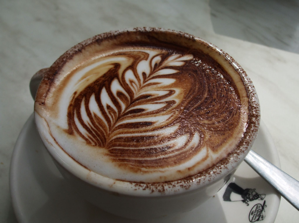 Here shown is a cappuccino with a “trendy” design made within the foam. Coffee “art” is a growing trend in metropolitan areas. (Vivian Evans/ CC BY-SA 2.0)