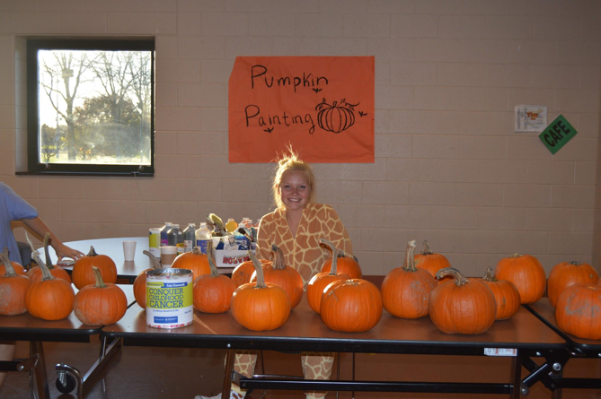 Kate Wilson, junior at HHS and member of MiniTHON, supervises pumpkin painting in the Trojan Cafe.  All proceeds of the Fall Fest went to support the Four Diamonds combatting pediatric cancer.  (Iliana Veguilla/Broadcaster)
