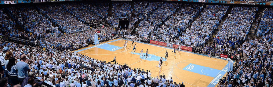 (Credit to UNC Athletics) Here UNC is playing their ACC rival, the Duke Blue Devils in the Dean Smith Center.  The Dean Smith Center is home to the UNC home basketball games. 
