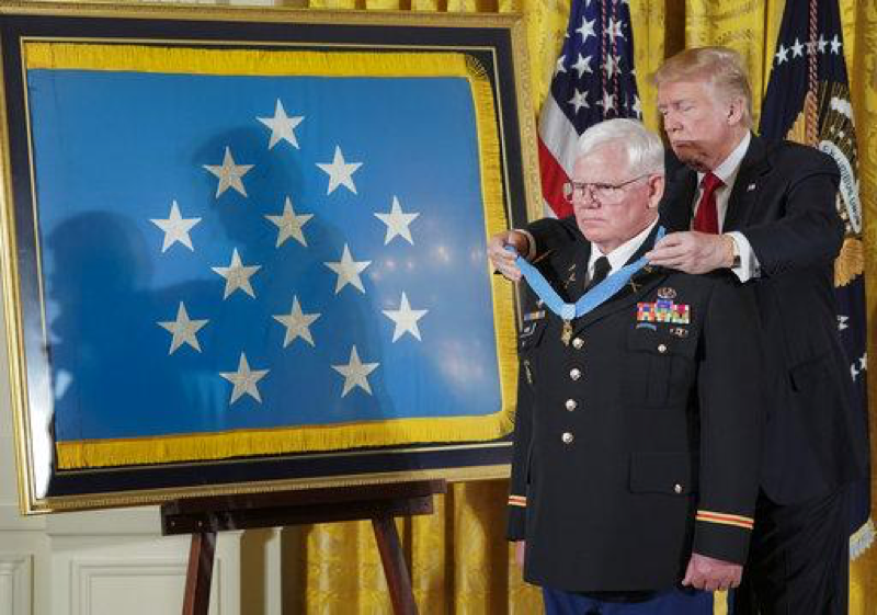 President Donald Trump bestows the nations highest military honor, the Medal of Honor, to retired Army Capt. Gary M. Rose, during a ceremony in the East Room of the White House in Washington, Monday, Oct. 23, 2017. (AP Photo/Pablo Martinez Monsivais)