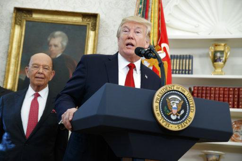 Secretary of Commerce Wilbur Ross listens as President Donald Trump speaks before meeting with winners from the National Minority Enterprise Development Week Awards Program, in the Oval Office of the White House, Tuesday, Oct. 24, 2017, in Washington. (AP Photo/Evan Vucci)
