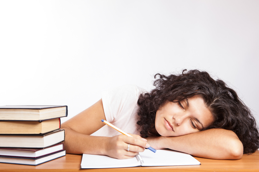 Shown here is a teen so tired she fell asleep during studying. In multiple other schools around the nation, students’ academic performance has gone up with the later start times. (CollegeDegrees360/CC BY-SA 2.0)