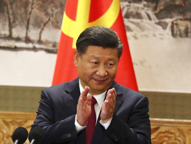 Chinese President Xi Jinping claps while addressing the media as he introduces new members of the Politburo Standing Committee at Beijings Great Hall of the People on October 25, 2017. On a proposal made public Sunday, Feb. 25, 2018, Chinas ruling Communist Party proposes removing a limit of two consecutive terms for the president and vice president. (AP Photo/Ng Han Guan)