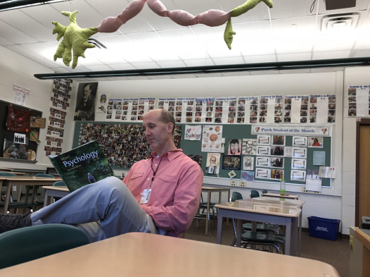 AP Psychology teacher, Pete Steelman, reads the Myers’ Psychology for AP 2nd Edition textbook in his classroom on February 28, 2018. AP Psychology was a new course beginning in the 2016-17 school year.(The Broadcaster/Lynn Dang)