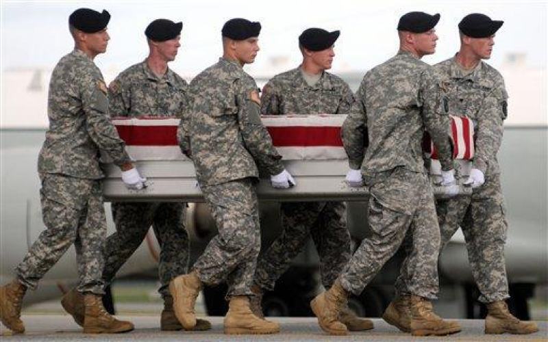 In this Sept. 22, 2009 file photo, an Army carry team carries a transfer case containing the remains of U.S. Army Spc. Michael S. Cote Jr., at Dover Air Force Base, Del. 2009 was the least deadly for American forces in Iraq since the war began, according to figures compiled by The Associated Press. (AP Photo/Steve Ruark, File)