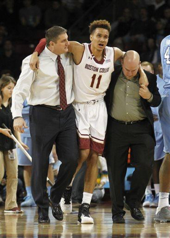 In this Feb. 9, 2016, file photo, Boston College head coach Jim Christian, left, helps forward A.J. Turner (11) off the court after an injury during the second half of an NCAA college basketball game against North Carolina, in Boston. (AP Photo/Stew Milne, File)